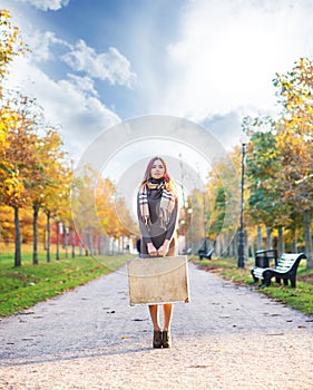 Beautiful girl with coloured hair holding a suitcase