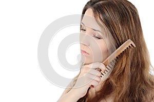 Beautiful girl combing her hair.