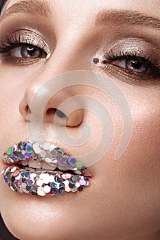 Beautiful girl with creative glitter make up lips. Beauty face.