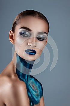 Beautiful girl with creative make-up . Bright colors blue lips. Conceptual art the cosmos, the universe