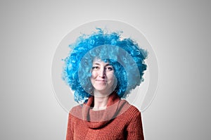 Beautiful girl with curly blue wig and turtleneck