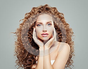 Beautiful girl with curly hair. Perfect female model face. Wavy hairstyle, haircare concept
