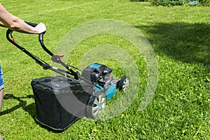 Beautiful girl cuts the lawn. Mowing lawns. Lawn mower on green grass. mower grass equipment. mowing gardener care work tool