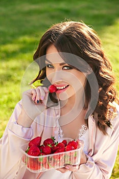 Beautiful girl with dark hair relaxing at summer picknic, eating