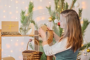 Beautiful girl decorate the room for Christmas