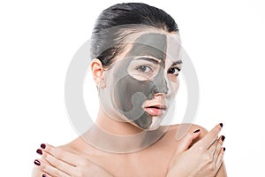 beautiful girl with different cosmetic facial masks looking at camera