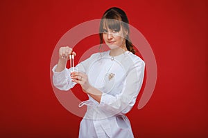 Beautiful girl doctor with a tuning fork stands