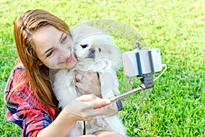 Beautiful girl with dog taken pictures of her self
