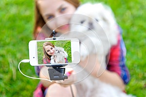 Beautiful girl with dog taken pictures of her self