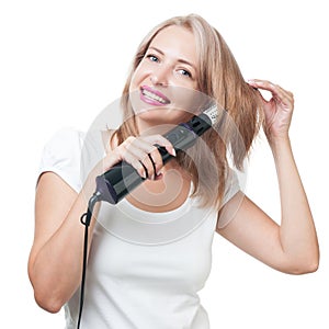 Beautiful girl doing hairstyle with hair brush