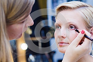 Beautiful girl doing make up, make up artist work