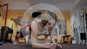 Beautiful girl doing plank at gym, fitness