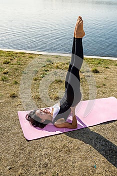 Beautiful  girl doing a yoga pose early morning before working time. Healhty lifestyle