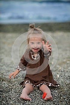 Beautiful girl with Down syndrome on the beach