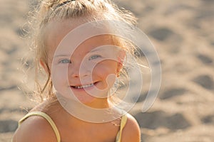 Beautiful girl with Down syndrome on the beach