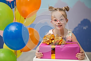 Beautiful girl with down syndrome with a birthday present