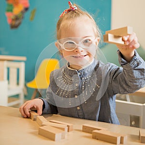 Beautiful girl with down syndrome engaged in class