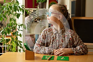 Beautiful girl with down syndrome engaged in class