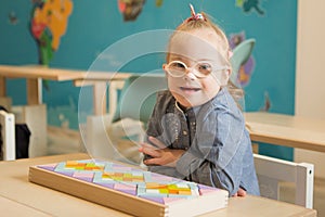 Beautiful girl with down syndrome engaged in class photo