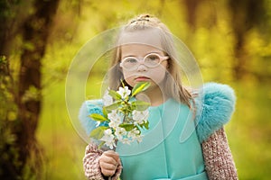 Beautiful girl with down syndrome holding spring flowers