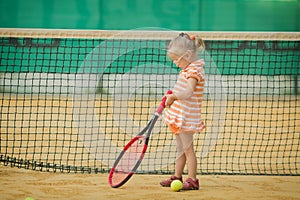 Beautiful girl with Down syndrome playing tennis