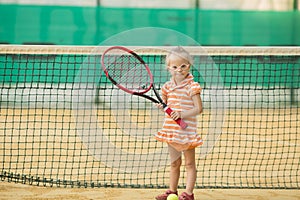 Beautiful girl with Down syndrome playing tennis
