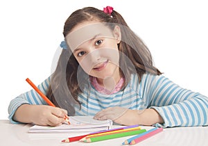 Beautiful girl is drawing with color pencils photo