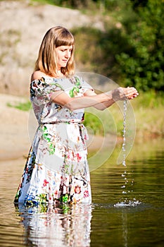 Beautiful girl in dress on the river