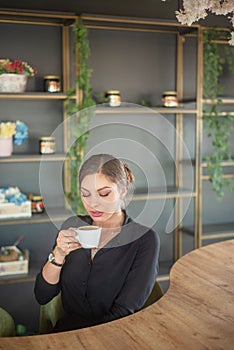 Beautiful girl drink cocktail and coffee, and typing on laptop