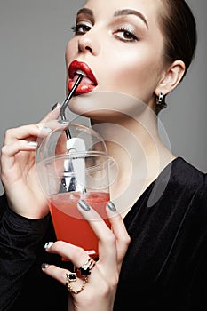 Beautiful girl drinking cocktail. make-up