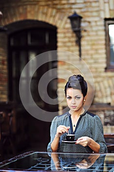 Beautiful girl drinking tea or coffee in cafe