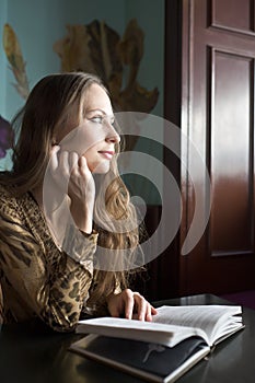 Beautiful Girl Drinking Tea or Coffee in Cafe