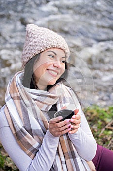 beautiful girl drinking tea near the river