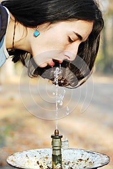 Beautiful girl drinking water