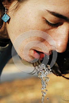 Beautiful girl drinking water