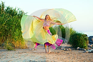 Beautiful girl in east dress before a sunset