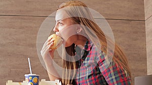 Beautiful girl eating fast food