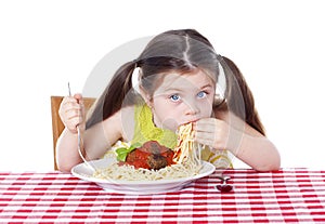 Beautiful girl eating pasta and meatballs