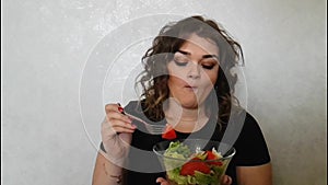 Beautiful girl eating salad emotion