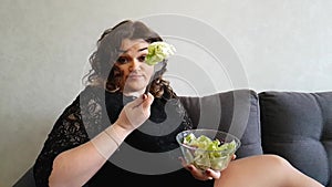 Beautiful girl eating salad the vitamin couch hungry amazement disgust emotion appetizer