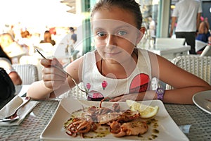 Beautiful girl eating seafood  at an italian restaurant