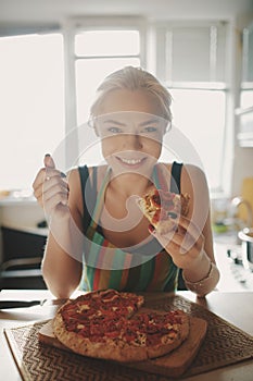 Beautiful girl eating tasty pizza