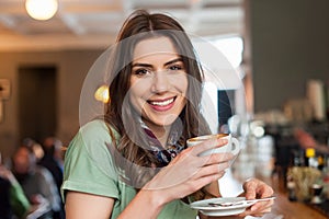 Beautiful girl enjoying a good coffee in the cafe shop