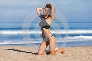 Beautiful girl enjoying sun bath on the beach