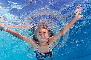 Beautiful girl enjoying swimming under water