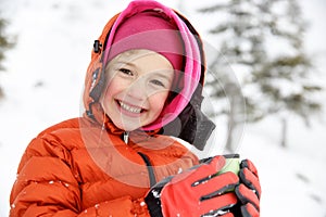 Beautiful girl, enjoying winter, drinking warm thermos tea