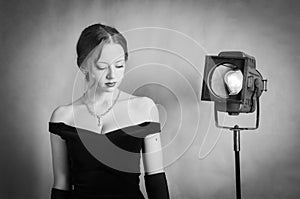 Beautiful girl in evening dress posing in studio