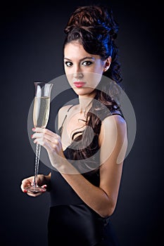 Beautiful girl in evening dress with wine glass. New Year's Eve.