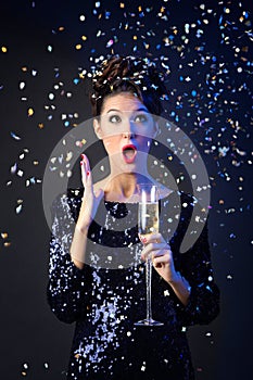 Beautiful girl in evening dress with wine glass. New Year's Eve.