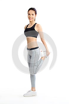 Beautiful girl exercise in sporty fashion and stretching muscles after fitness training